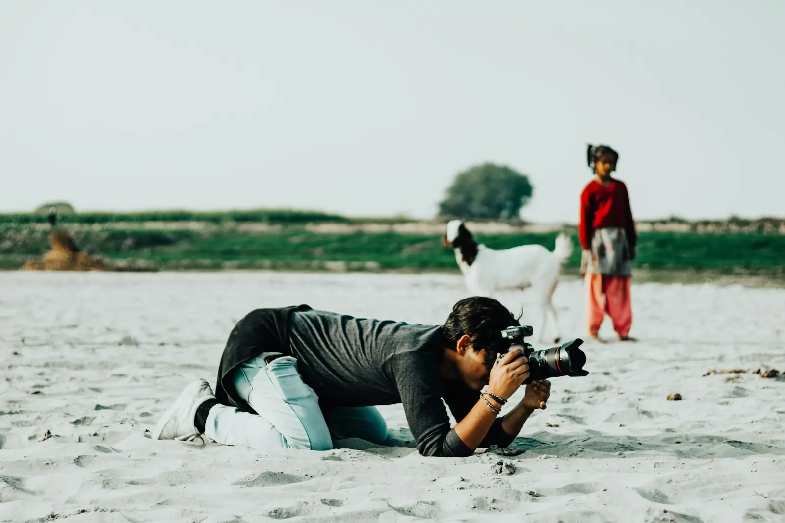 Photographer showing a couple photos on the camera screen on a beach in Thailand